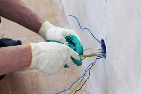 Worker puts the wires Stock Photos