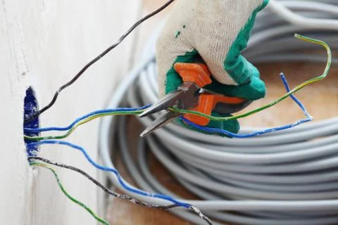 Worker puts the wires Stock Photos