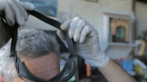 Worker putting on goggles Stock Footage 753570