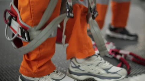 Worker putting on safety harness during training Stock Footage 321314521