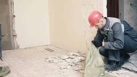 A worker is putting soil debris in a bag Stock Footage 99791608