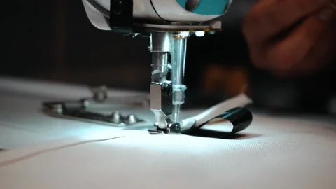 Worker putting tag onto fabric ready to be sewed Stock Footage 135269779