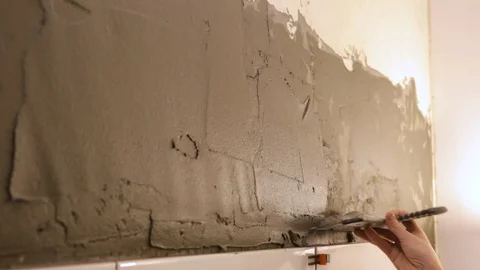 Worker putting tile glue on wall 库存影片 128412749