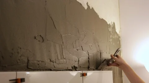 Worker putting tile glue on wall Video stock 128412778