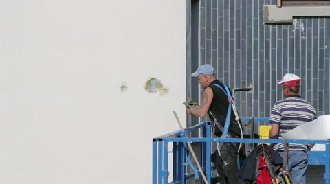 Worker putty crack in the facade of a building Stock Footage 49570098