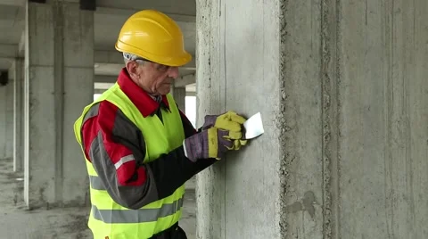 Worker with putty knife at construction site Stock Footage 50600457