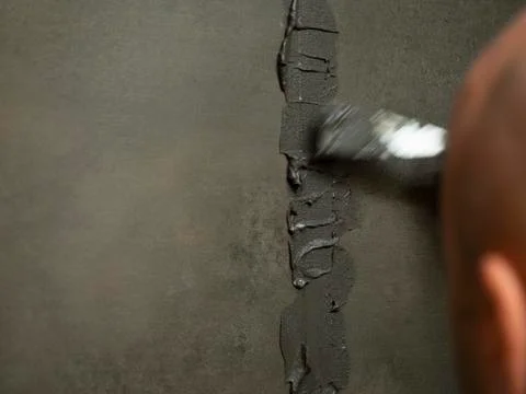 Worker putty shower on construction site for renovation.. Stock Photos