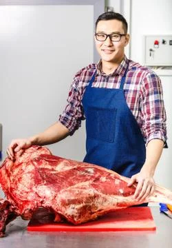 Worker with raw meat Stock Photos