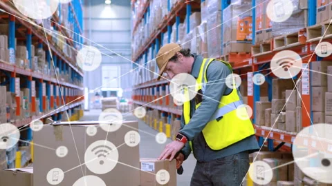 Worker reaching for parcel in warehouse aisle, scanning labels and showing Stock Footage 331048434