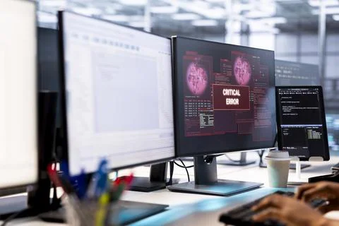 Worker receiving critical error notification on PC in data center workspace Foto stock
