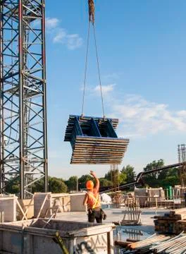 Worker receiving scaffolding pieces Stock Photos