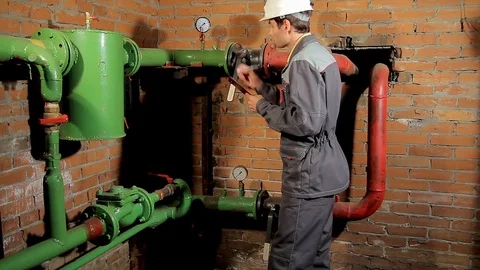 The worker records the readings of the manometer on the clipboard. The engineer Stock Footage 77122803