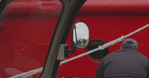 Worker on Red Ship with Mirror Reflection Stock Footage 336721777