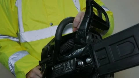 Worker In Reflective Uniform With Chainsaw Stock-Footage 220016747