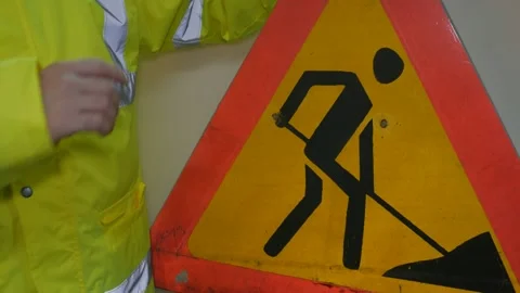 Worker In Reflective Uniform With Road Sign Stock Footage 220016833
