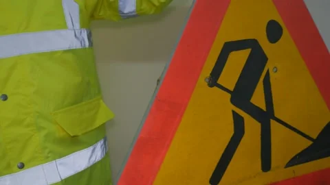 Worker In Reflective Uniform With Road Sign Stock Footage 220433271