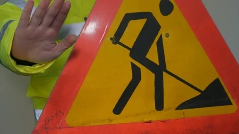 Worker In Reflective Uniform With Road Sign Stock Footage 220434036