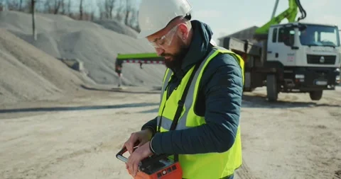 A worker with a remote control in his hands controls a pump for concrete Stock Footage 277595643