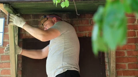 Worker remove old paint from the wooden surface with sandpaper Stock Footage 221122929