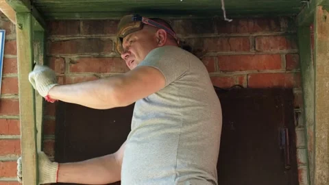 Worker remove old paint from wooden surface in porch with sandpaper Stock Footage 235766465