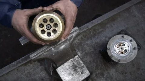 The worker removes the head of the hydraulic distributor. Tractor flow control Stock Footage 75330800