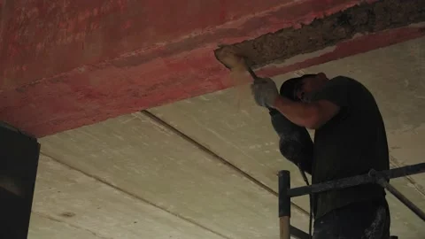 A worker removes the old ceiling in the room where major repairs are being made Stock Footage 141261619