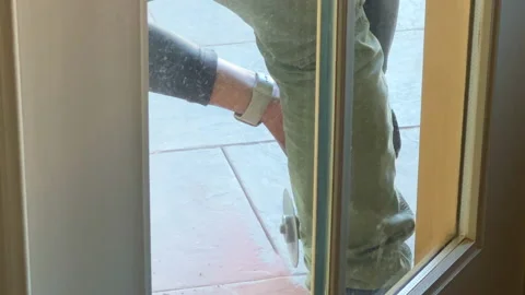 Worker removes old tile by drilling out the old grout Stock Footage 212479593