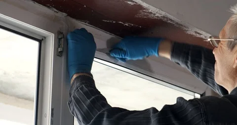 Worker removes the plastic seal from the white window. repair in new apartment Stock Footage 128229944