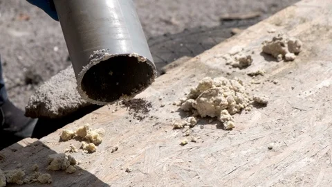 A worker removes solid deposits from grease. Stock Footage 129708092