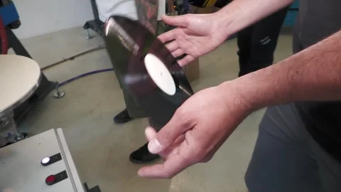 Worker Removing and Inspecting Pressed Vinyl Record Stock-Footage 343659152