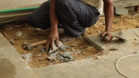 Worker is removing broken tiles. Cleaning waste tiles aside. working hard. Stock Footage 245093290