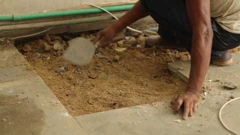 Worker is removing broken tiles. Cleaning waste tiles aside. working hard. Stock Footage 245093545