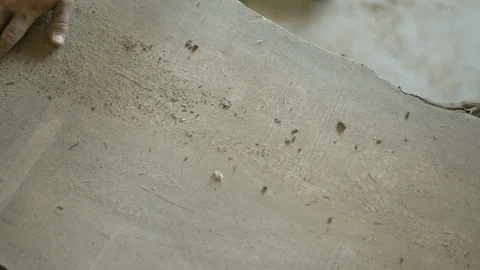 Worker removing dust from the surface of the wood with his hand Stock Footage 87613569