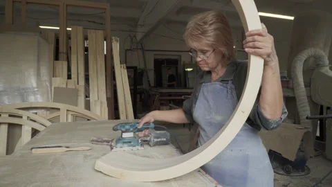 A Worker is removing the outer layer of wood for the detail quality improvement Stock Footage 243517702
