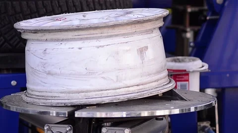 Worker removing rubber wheels on a metal bag at a car workshop Stock Footage 60787803