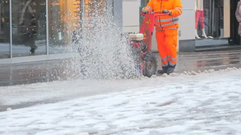 Worker removing snow with snowplower. Winter in city Видео 96210139