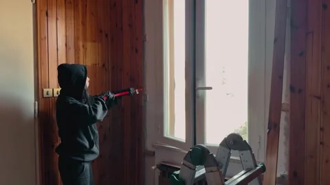 Worker Removing Wooden Wall Paneling With Crowbar During Home Renovation Near Stock Footage 333788640
