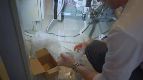 Worker repair dishwasher in the kitchen. Stock Footage 250441943