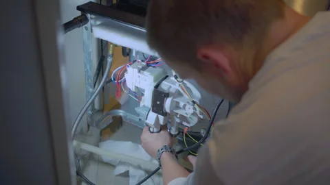 Worker repair dishwasher in the kitchen. Stock Footage 250442069