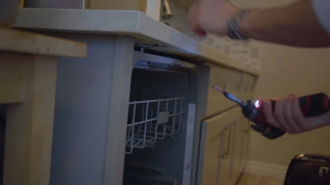 Worker repair dishwasher in the kitchen. Stock Footage 250442525