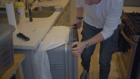 Worker repair dishwasher in the kitchen. Stock Footage 252262311