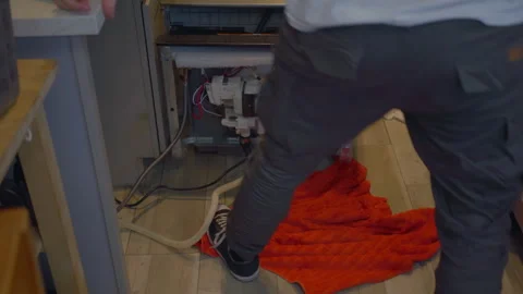Worker repair dishwasher in the kitchen. Stock Footage 252262509