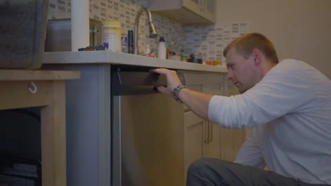 Worker repair dishwasher in the kitchen. Stock Footage 252262836