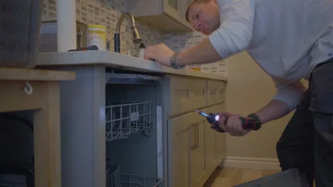 Worker repair dishwasher in the kitchen. Stock Footage 252262882