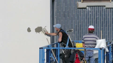 Worker repair the facade, plaster walls, using a lift Stock Footage 49571994