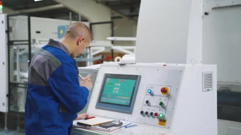 Worker repairs, adjusts operation of production equipment at factory. Employee Stock Footage 281332660