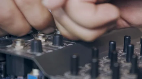 A worker repairs an audio mixer closeup Stock Footage 126394336