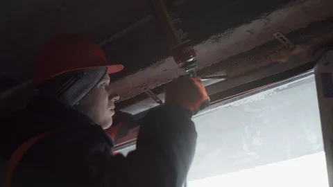 Worker repairs the cracks in the walls with mounting foam Stock Footage 82295598