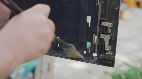 A worker repairs a game console and cleans dust Stock Footage 108521202