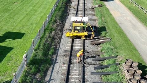 Worker Repairs Train Tracks at Rural Location Using Heavy Machinery on Sunn.. 스톡 동영상 319093653